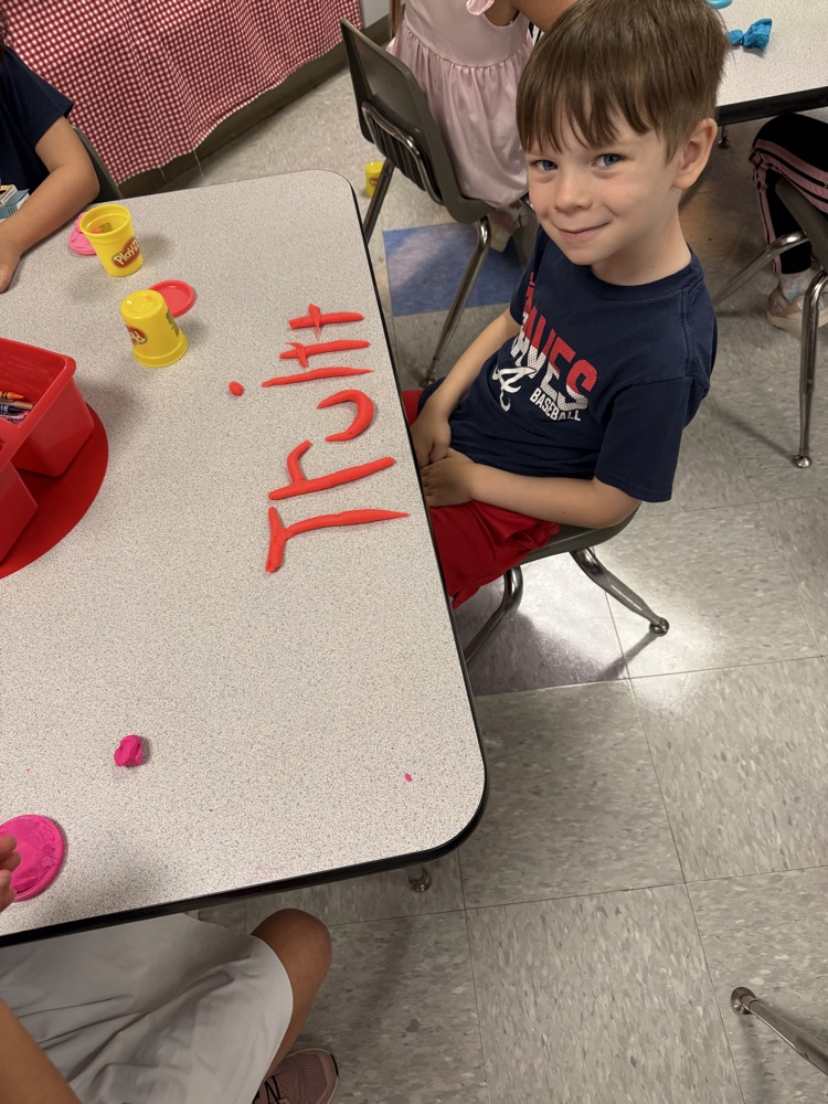 students making names with playdough 