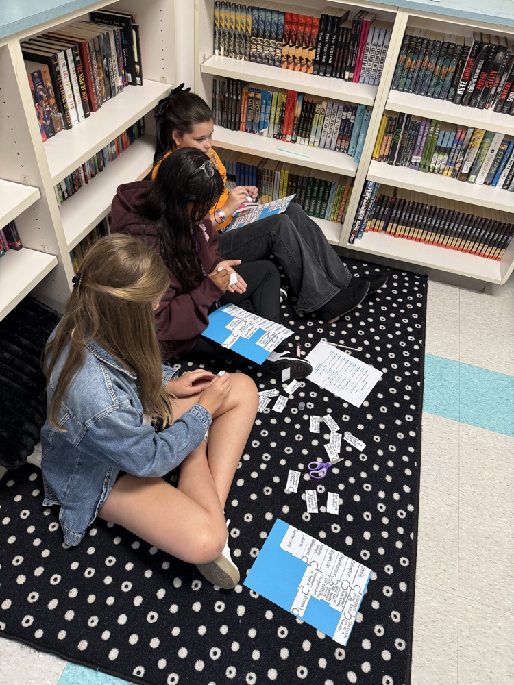 students sitting on a carpet