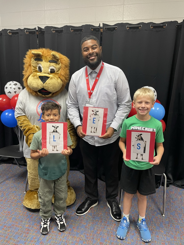 students with principal and mascot