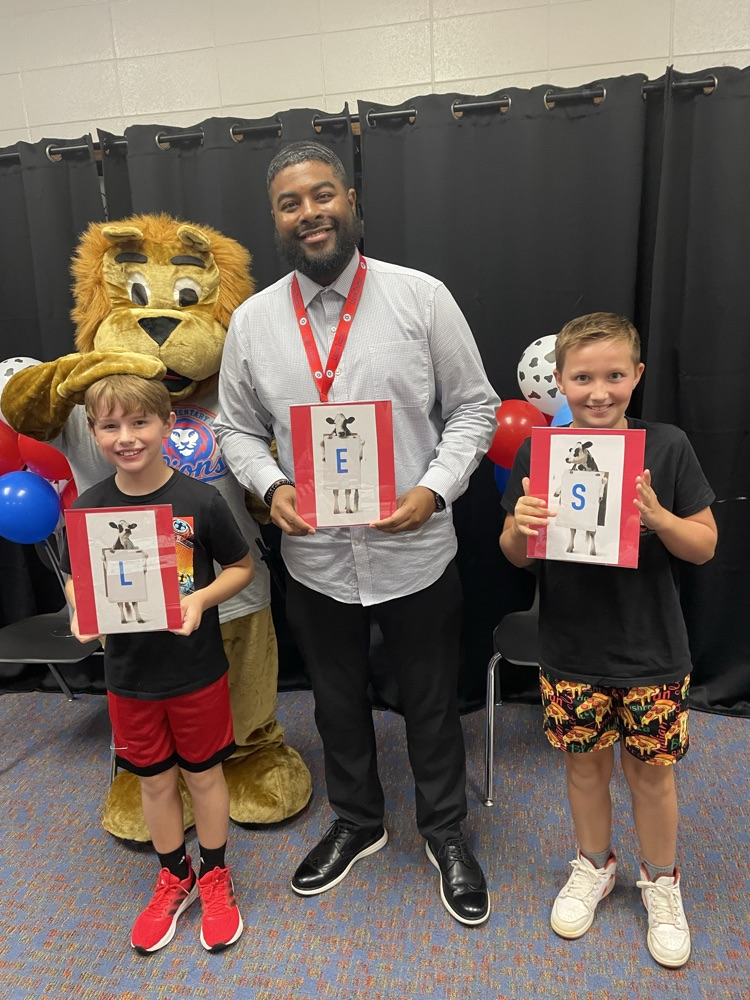 students with principal and mascot
