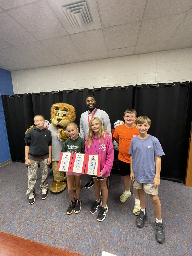 students with principal and mascot