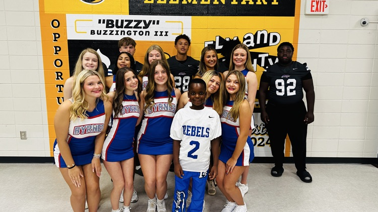 cheerleaders with student