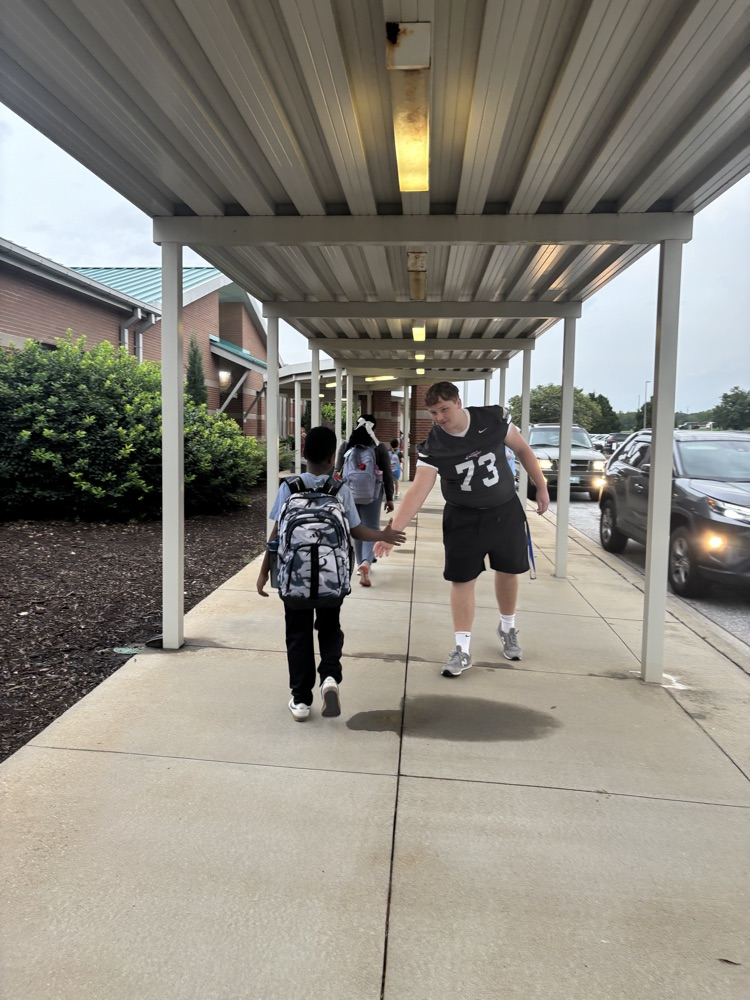 Player greeting student