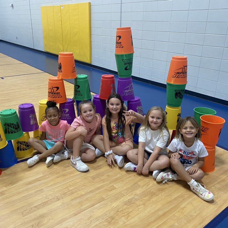 picture of students with stacking buckets in gym