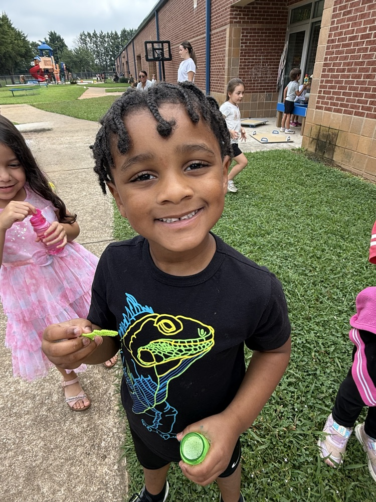 k5 students blowing bubbles outside 