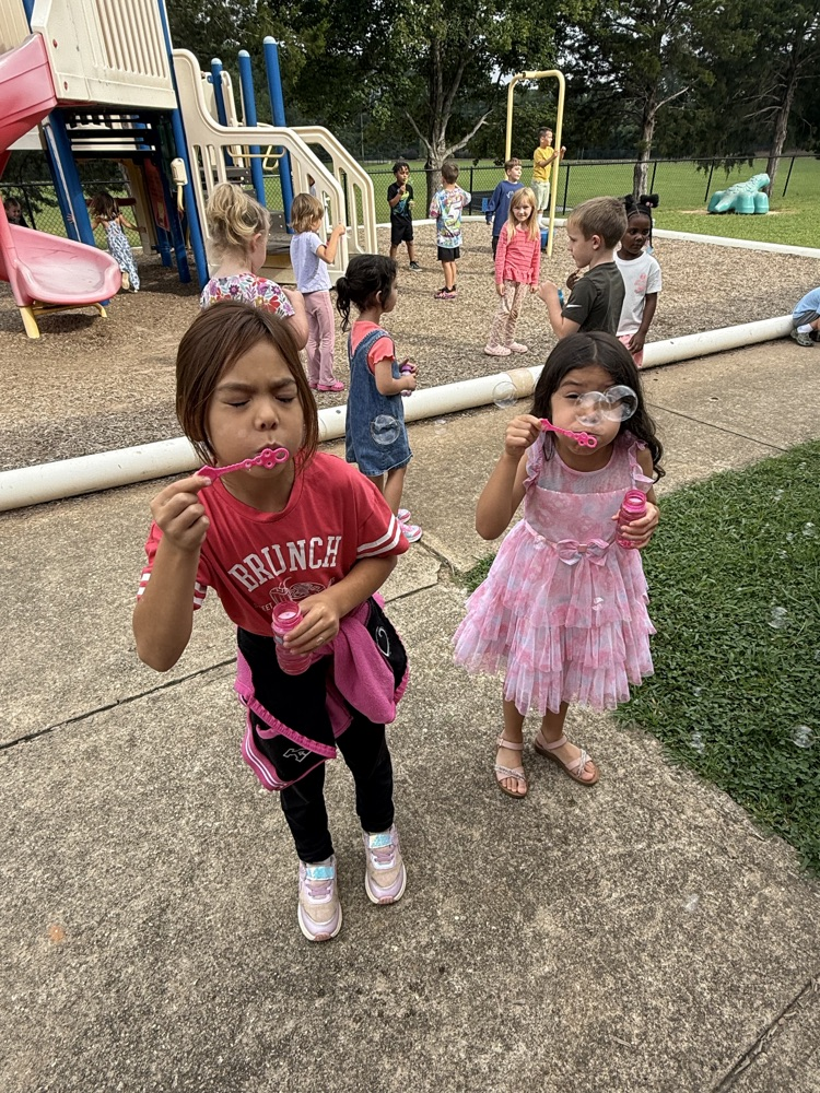 k5 students blowing bubbles outside 