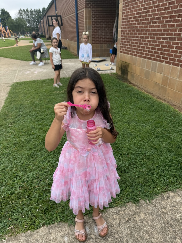 k5 students blowing bubbles outside 