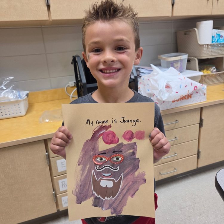 picture of a student holding artwork