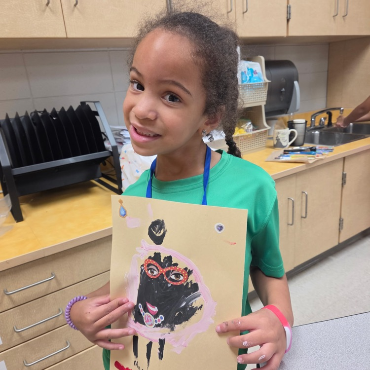 picture of a student holding artwork