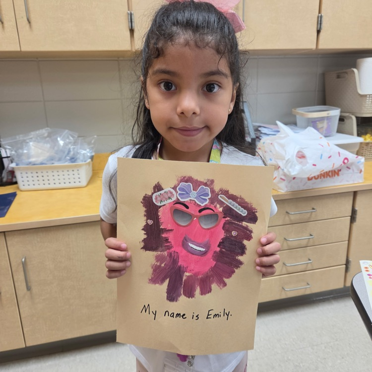 picture of a student holding artwork
