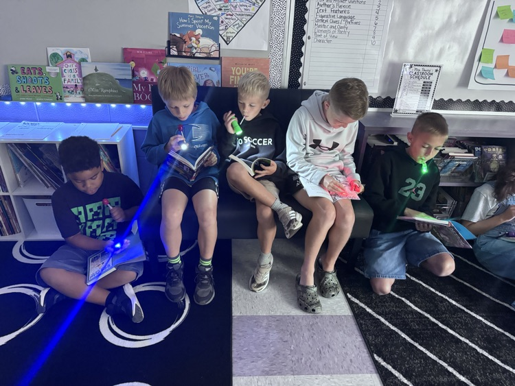 students reading with flashlights 