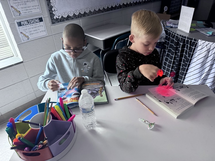 students reading with flashlights 