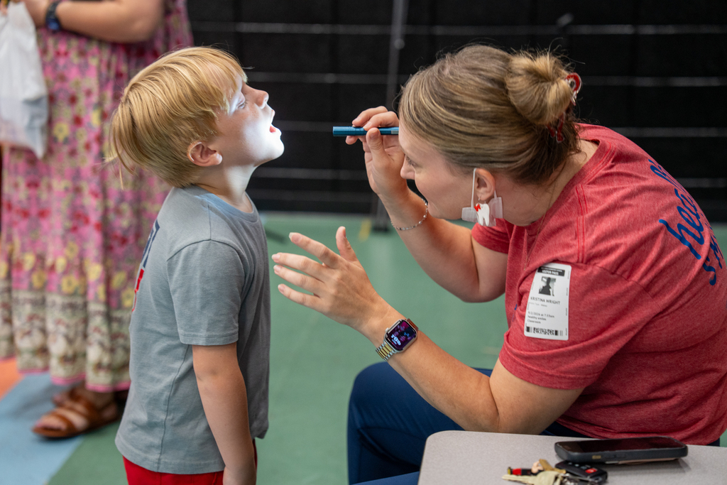 dentist checking student's teeth