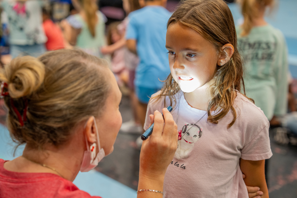 dentist checking student's teeth