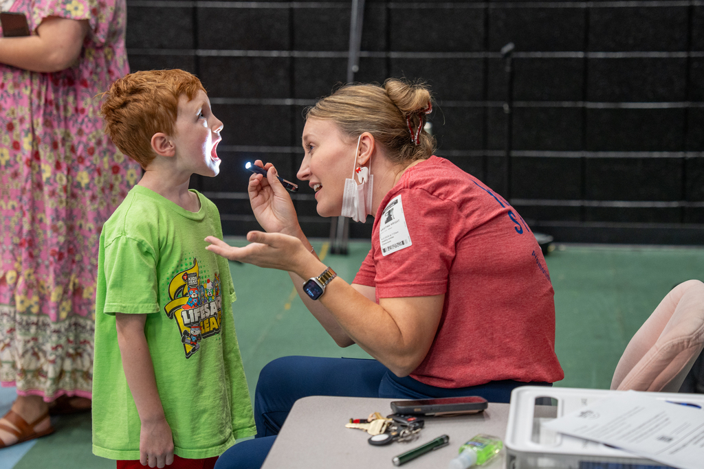 dentist checking student's teeth