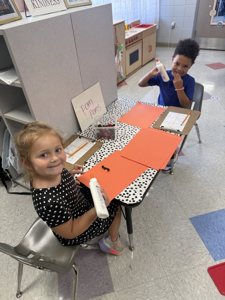 students working in their math stations to learn numbers