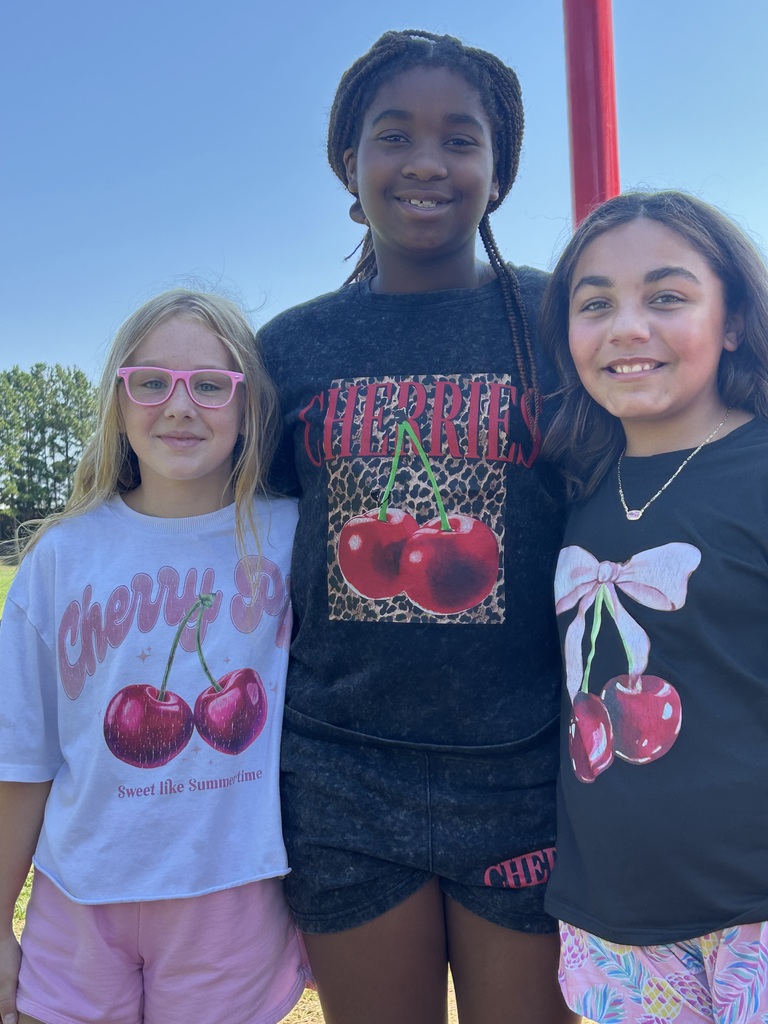 three girls wearing cherry themed tshirts