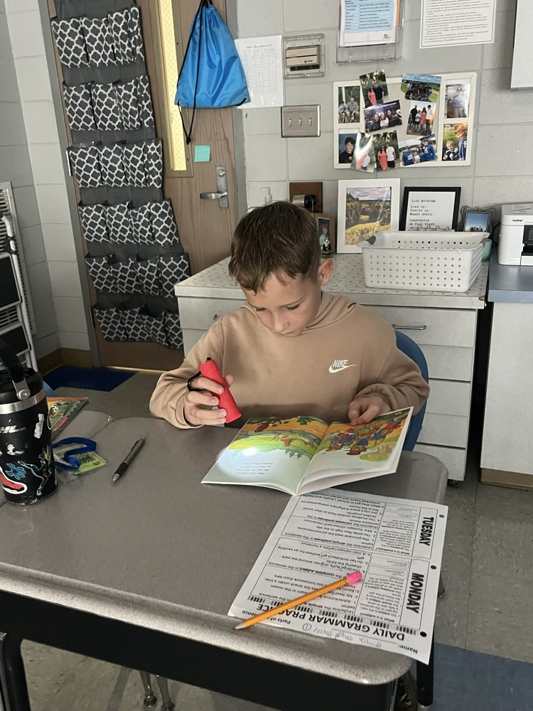 students reading with flashlights