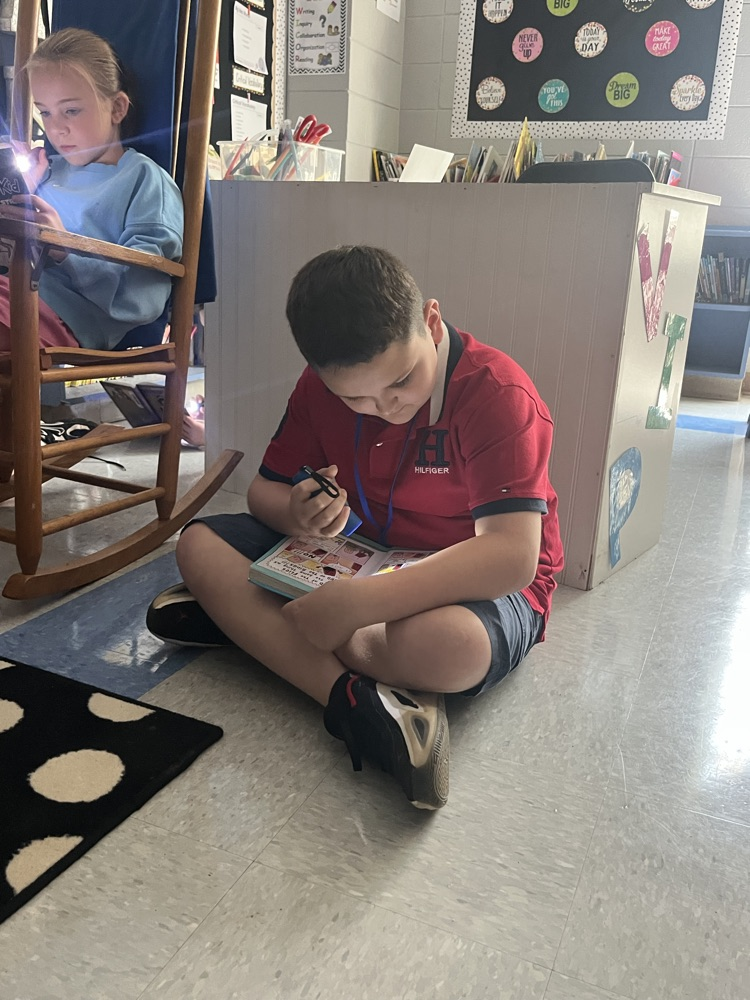 students reading with flashlights