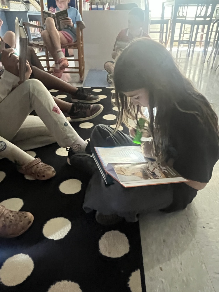 students reading with flashlights