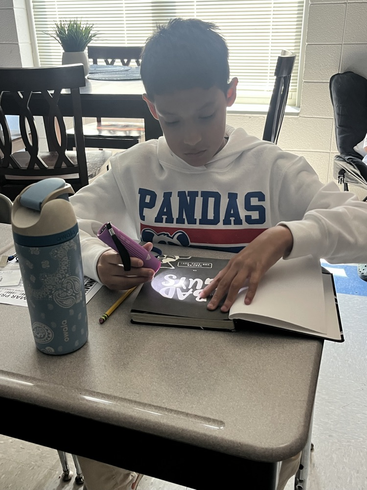 students reading with flashlights