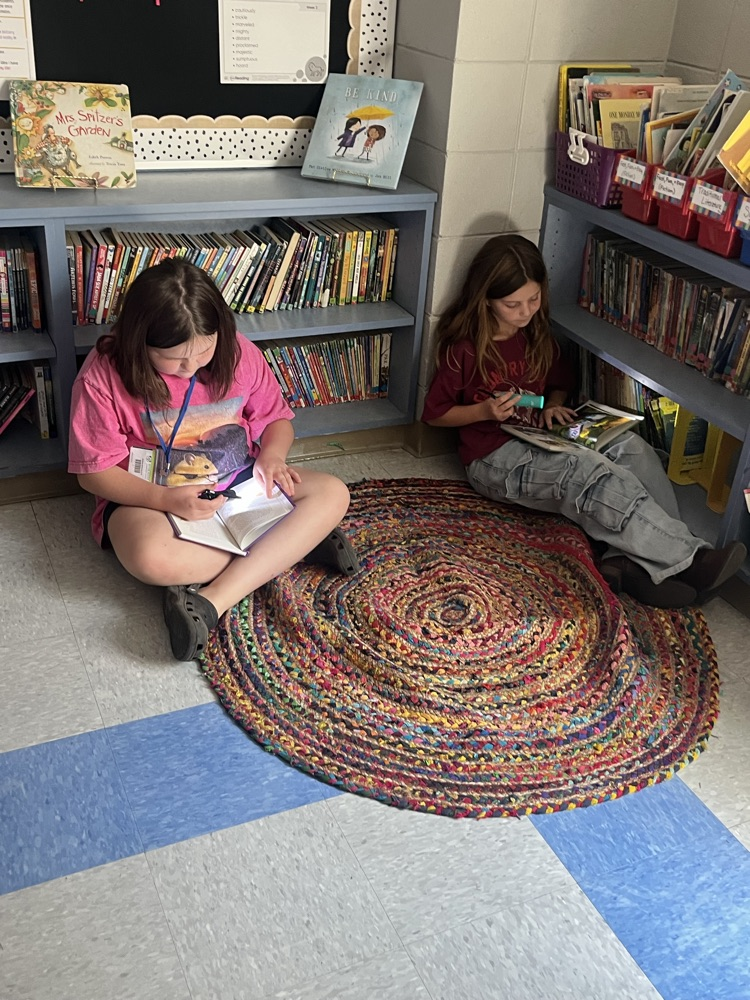 students reading with flashlights