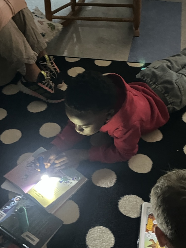students reading with flashlights