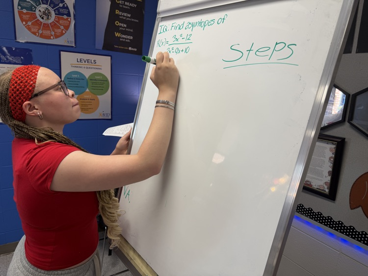 student writing on board