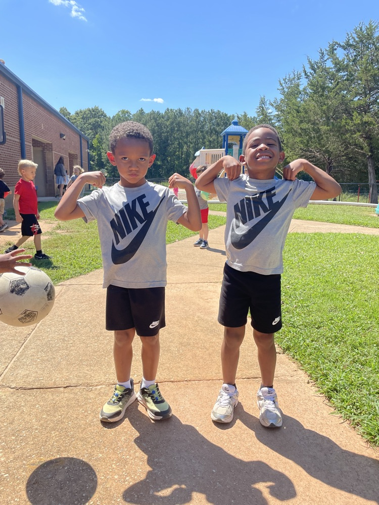 two k5 students in matching shirts and shorts 