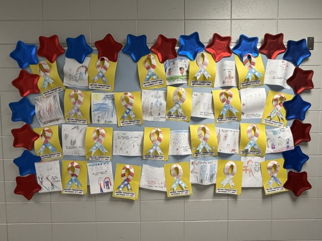 student writing on a bulletin board