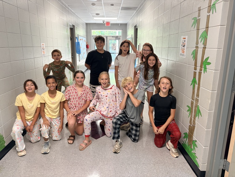 students posing in the hallway in their pjs