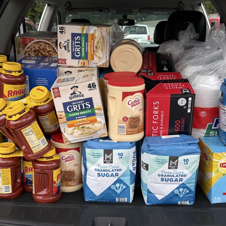 this image shows students loading up supplies for the Greer soup kitchen. 