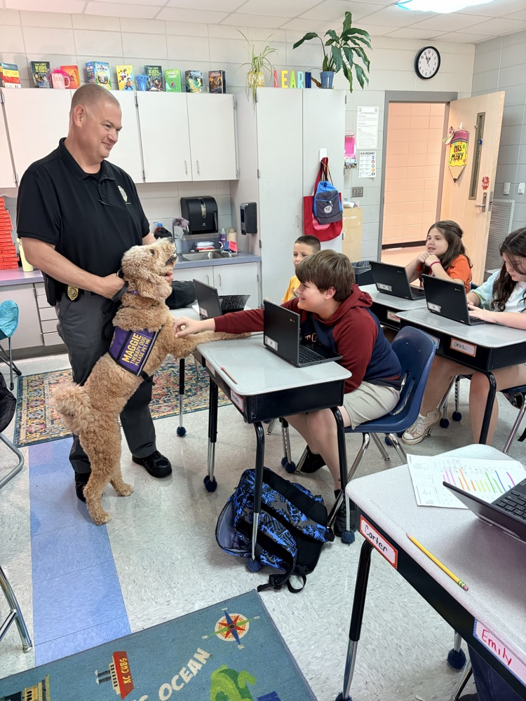 K9 Maggie greeting students