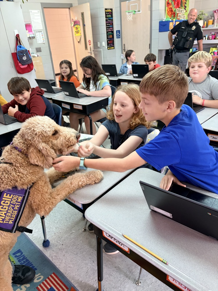 K9 Maggie greeting students