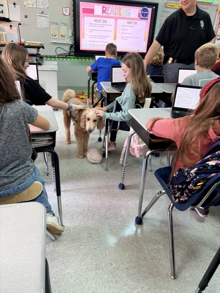 K9 Maggie greeting students