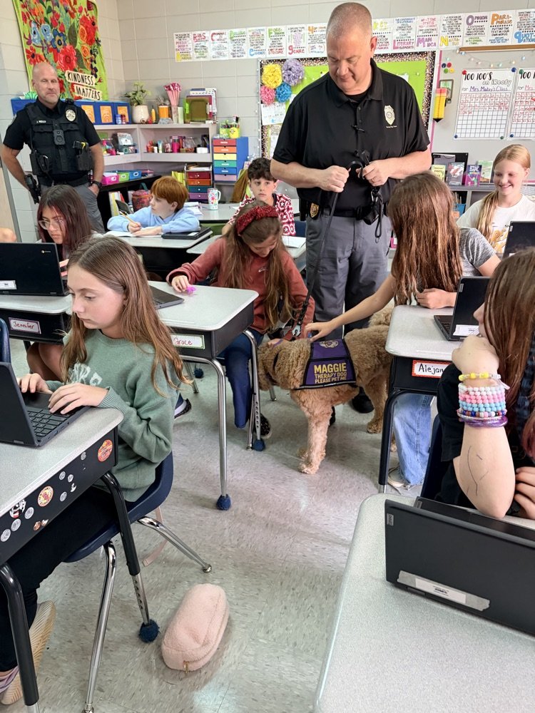 K9 Maggie greeting students