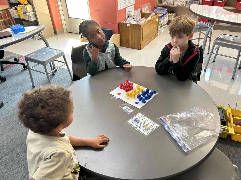 This image shows students sorting and counting bears based on size and color.
