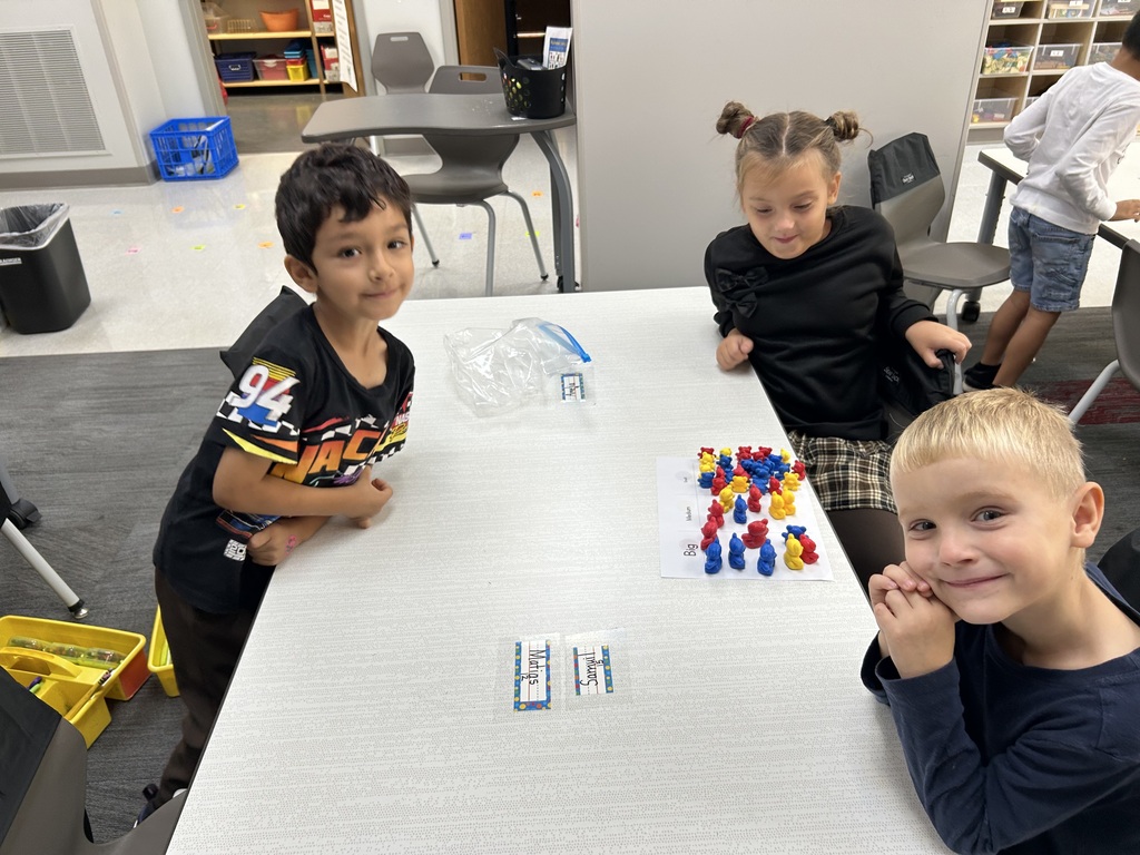 This image shows students sorting and counting bears based on size and color.
