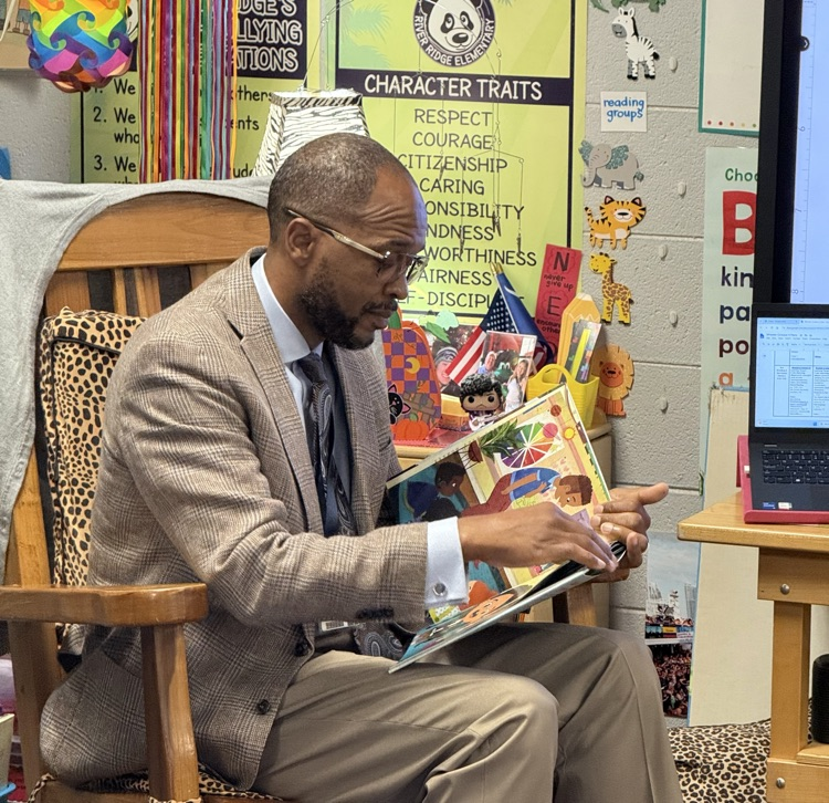 Dr. Gary reading to a class of K5 students