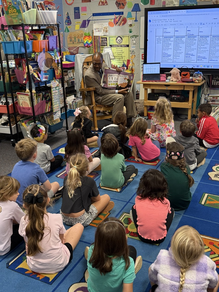 Dr. Gary reading to a class of K5 students