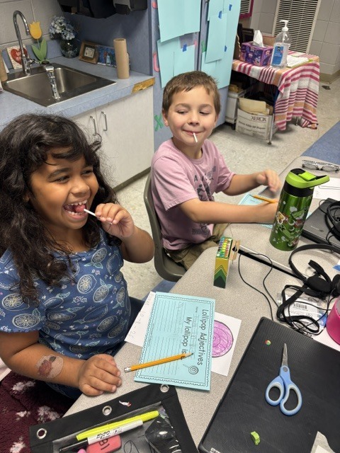 students tasting candy and describing it on paper