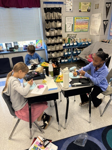 students tasting candy and describing it on paper