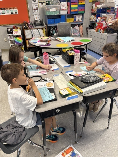 students tasting candy and describing it on paper