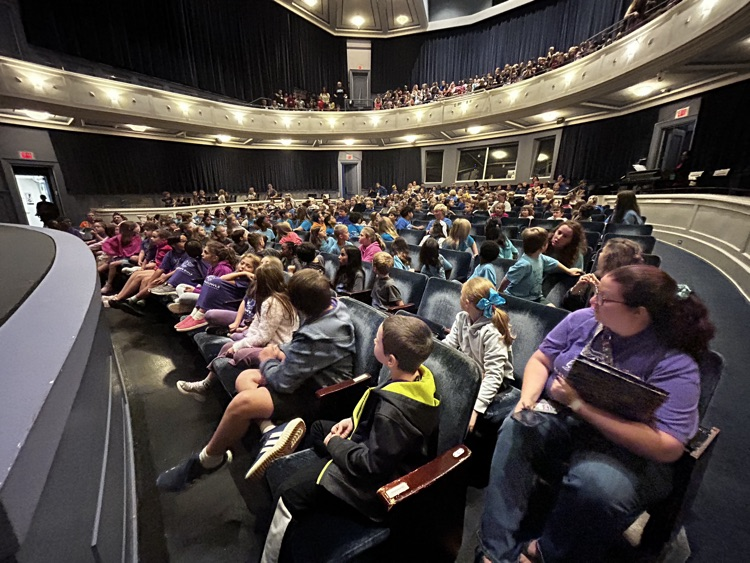 students sitting in theater audience