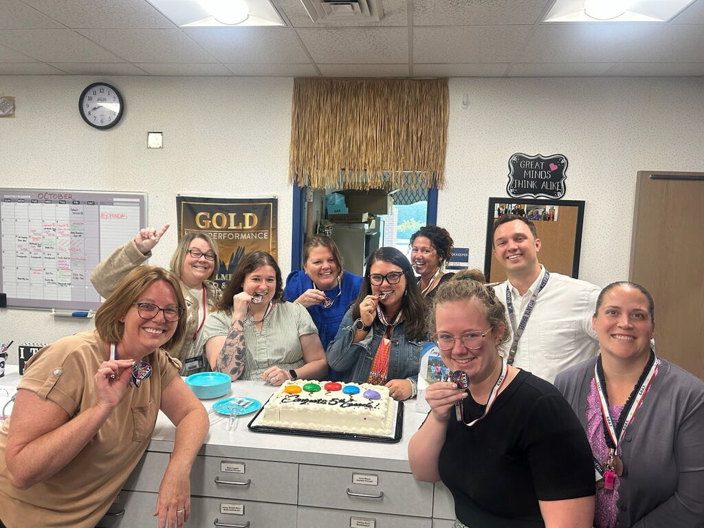fifth grade team with admin and a cake
