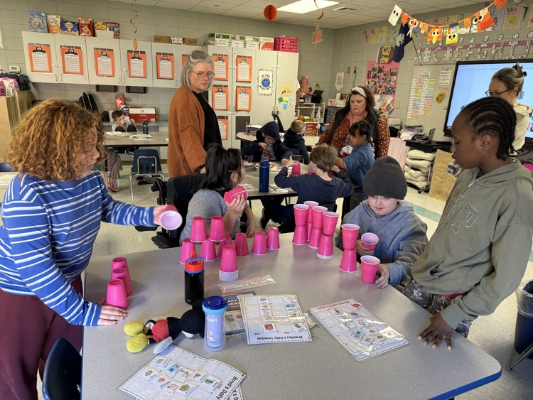 students building with cups