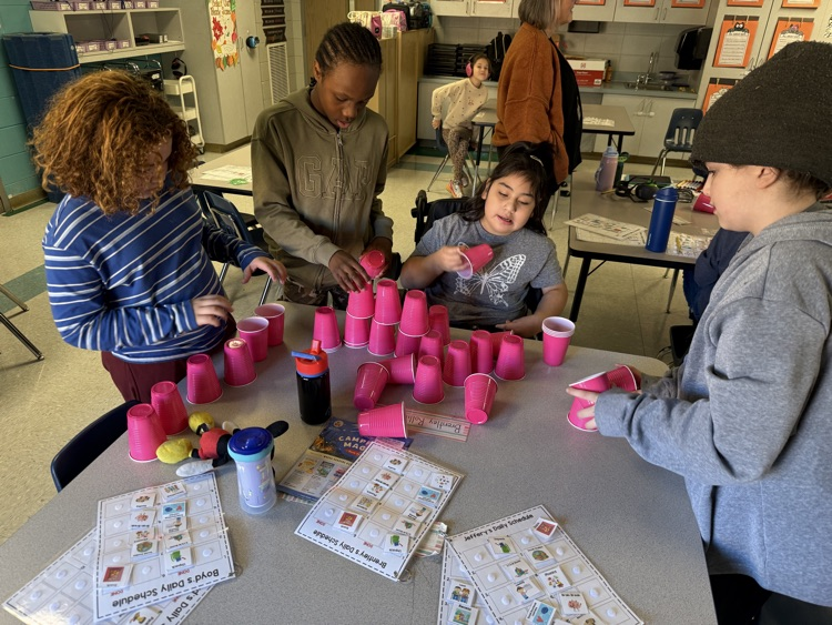 students building with cups