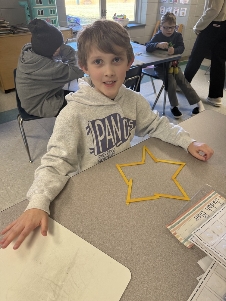 students building with popsicle sticks 