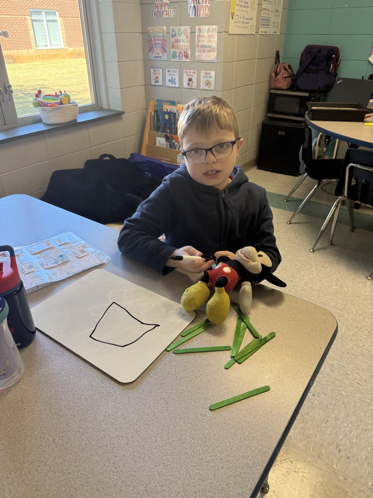 students building with popsicle sticks 