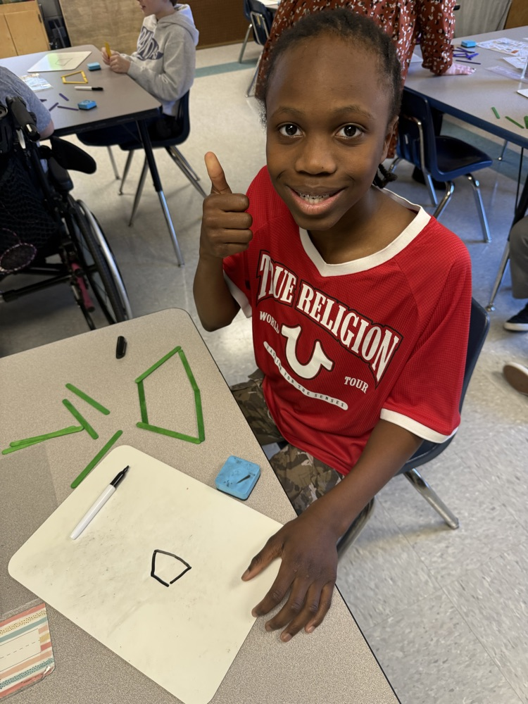 students building with popsicle sticks 